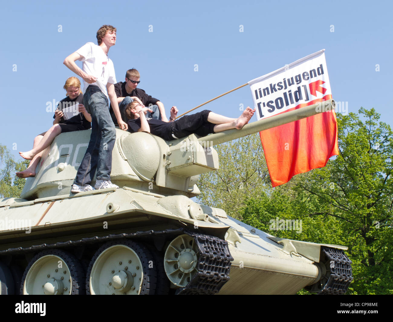 Berlin - The Russian War Memorial and tank. 17 Juni Strasse - May day celebrations with young men on the tank Stock Photo