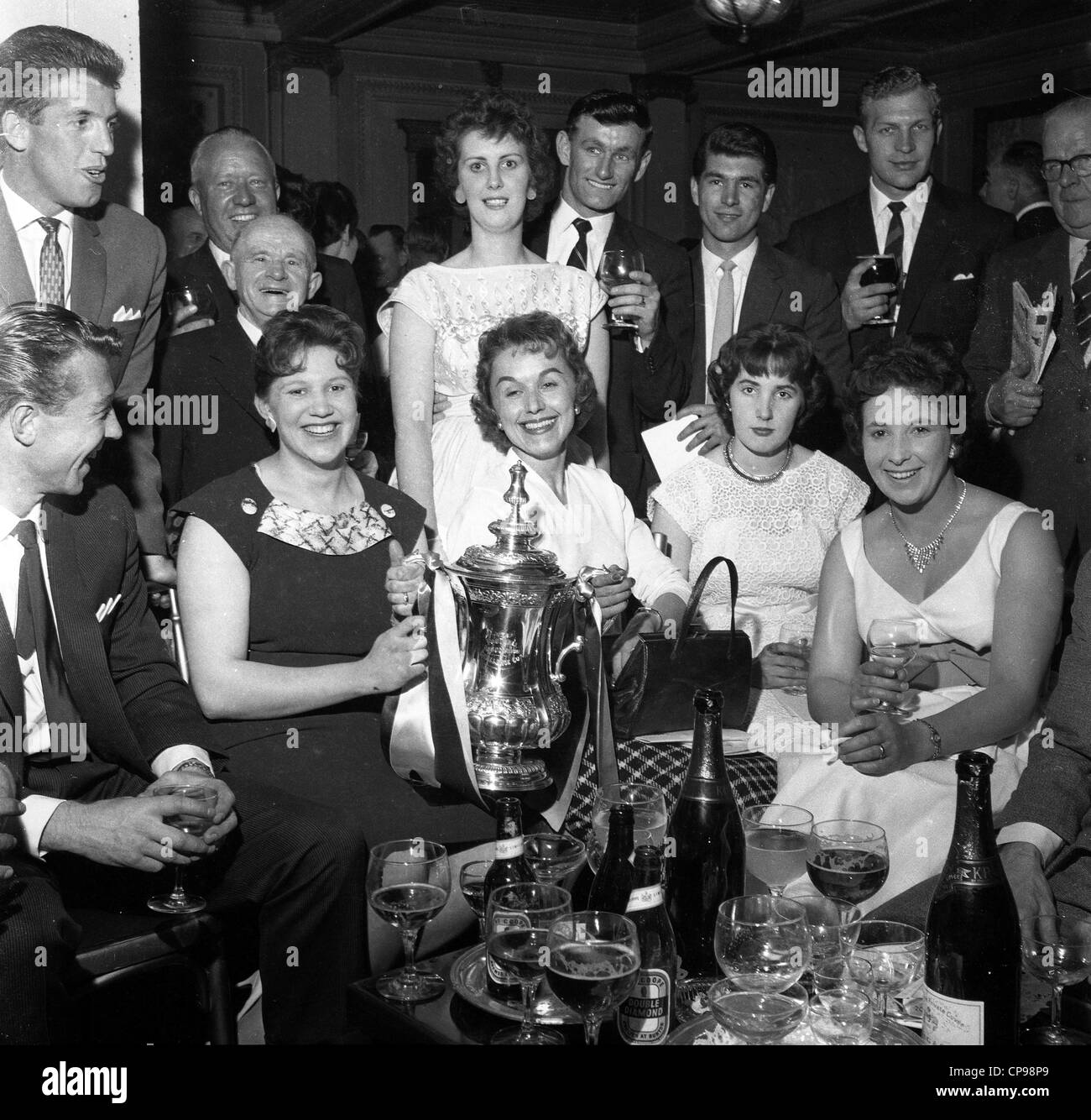 Wolverhampton Wanderers footballers celebrating 1960 FA cup win at the Cafe Royal with their wives. LtoR Peter Broadbent, George Showell, Jimmy Murray, Des Horne, Malcolm Finlayson. footballers wives partners Britain 1960s celebration celebrations party Stock Photo