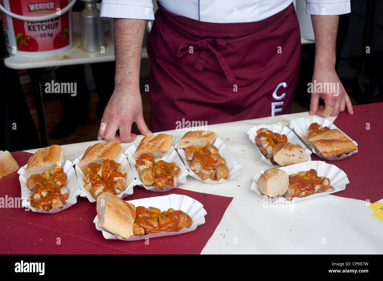Paris, France - Curry Wurst, typical German food made of sausage and curry sauce with bread. Stock Photo