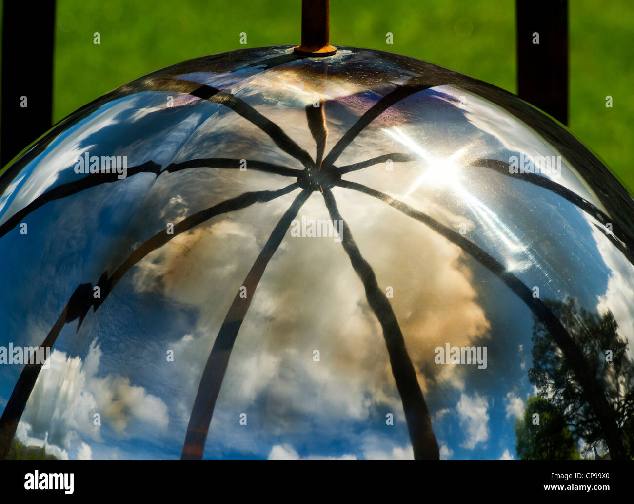 Chrome Globe sphere reflecting cloudy blue sky abstract Stock Photo