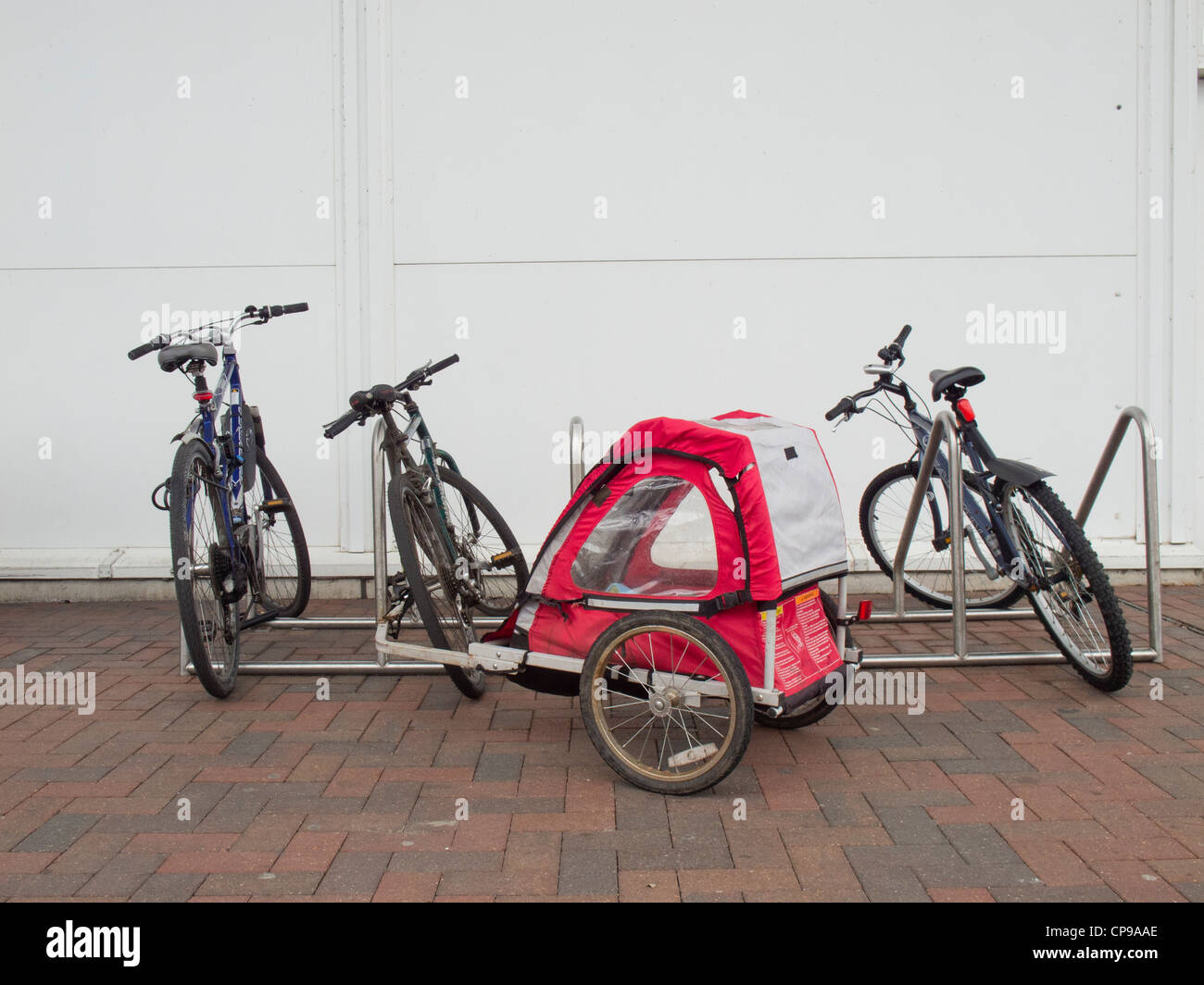 Bicycle parking with bicycles and bike trailer. Stock Photo