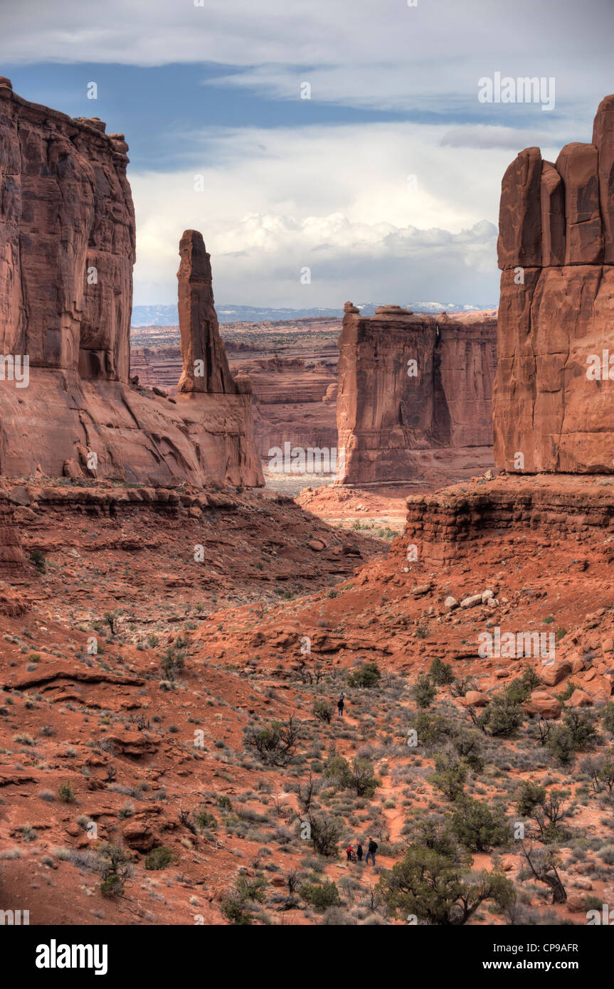 Hikers on the Park Avenue trail in Utah's Arches National Park on a spring day Stock Photo