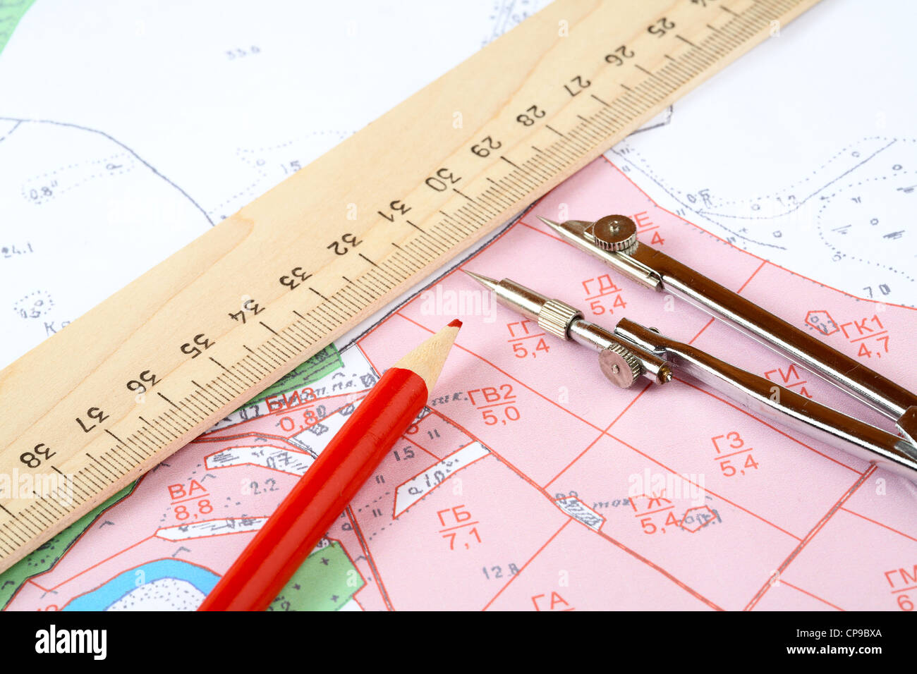 Red pencil compasses and ruler on a topographic map Stock Photo