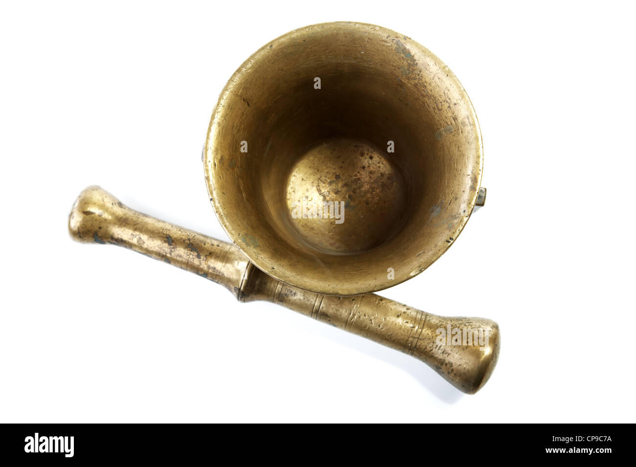 Brass mortar with a pestle isolated on a white background Stock Photo