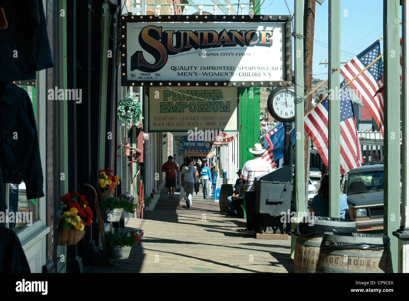 Decorative signs hang from roof of covered walkway on C Street over wooden  walkway Stock Photo - Alamy