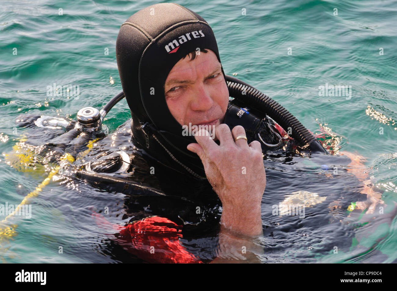 Caucasian male SCUBA diver diving floating positively buoyant at ocean