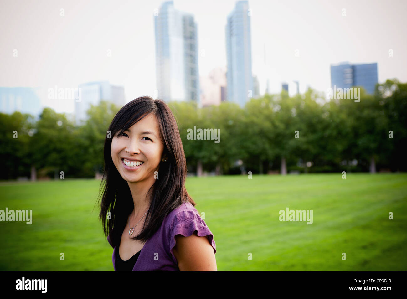 Woman smiling in park Stock Photo - Alamy