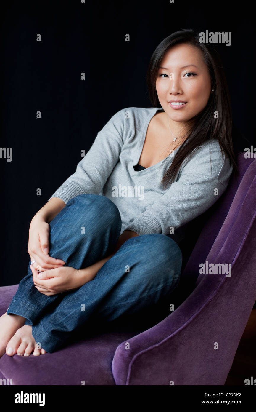 Black woman sitting on chair hi-res stock photography and images - Alamy