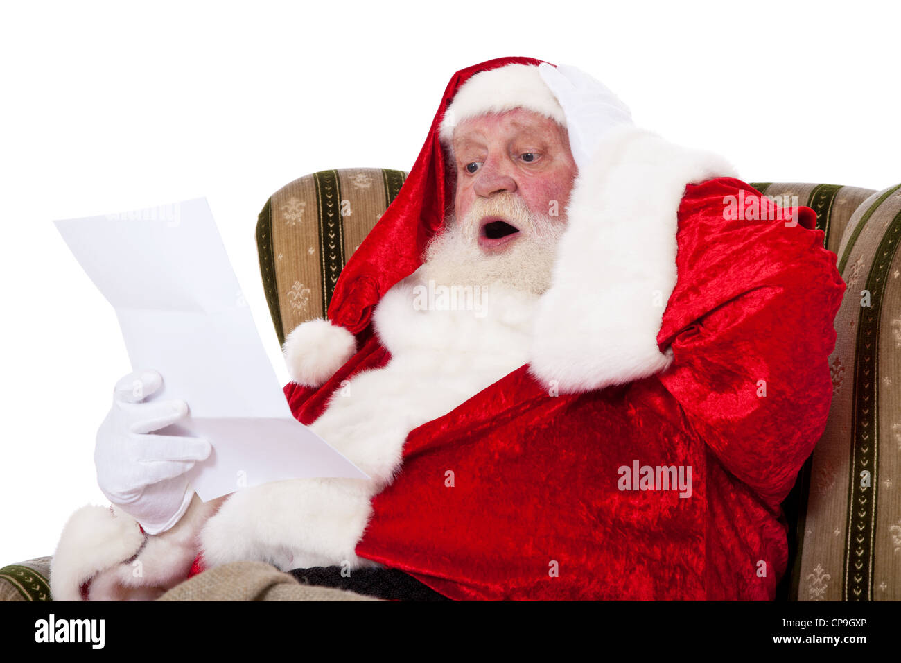 Santa Claus in authentic look reading wish list with surprised facial ...