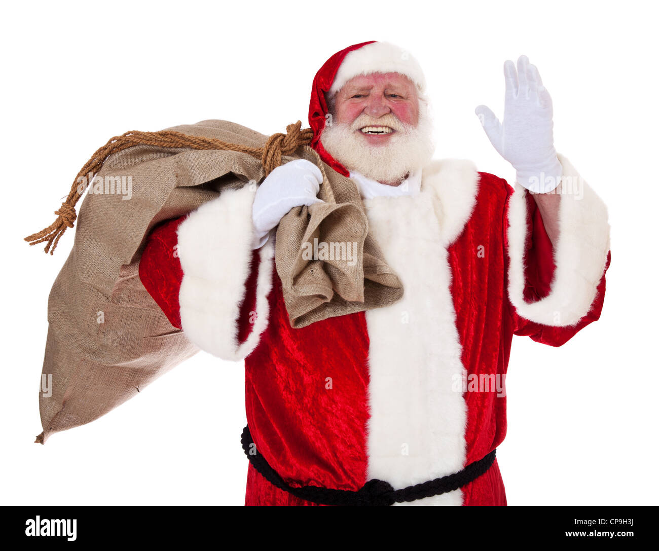Santa Claus in authentic look carrying bag of presents. All on white ...