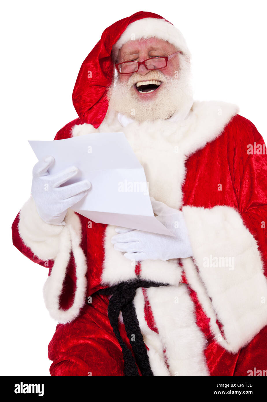 Santa Claus in authentic look having fun while reading the wish list. All on white background. Stock Photo