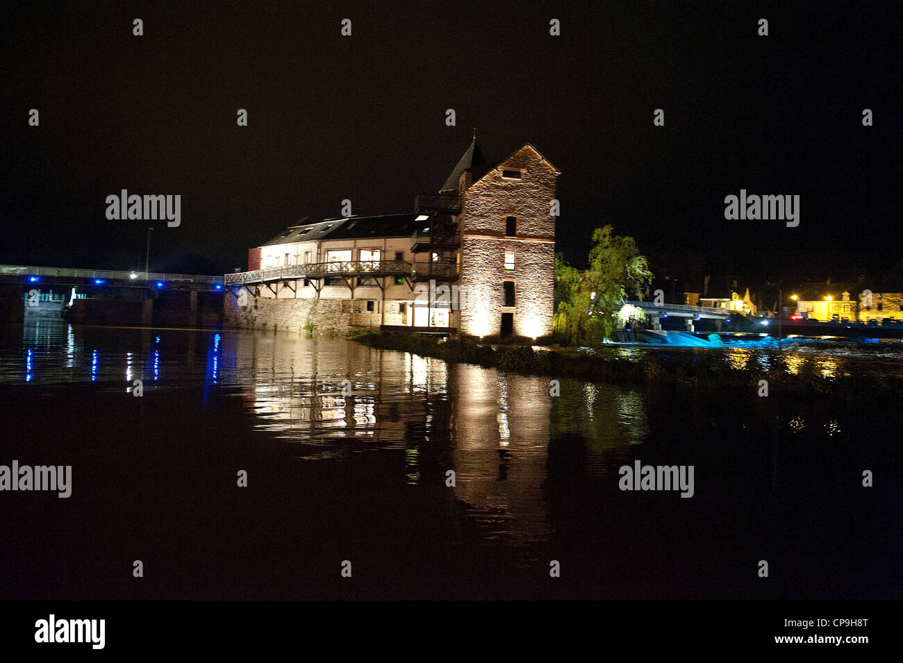 The old mill of Messac, now an event location, sits on a bridge above the Vilaine river in central Britanny, France Stock Photo