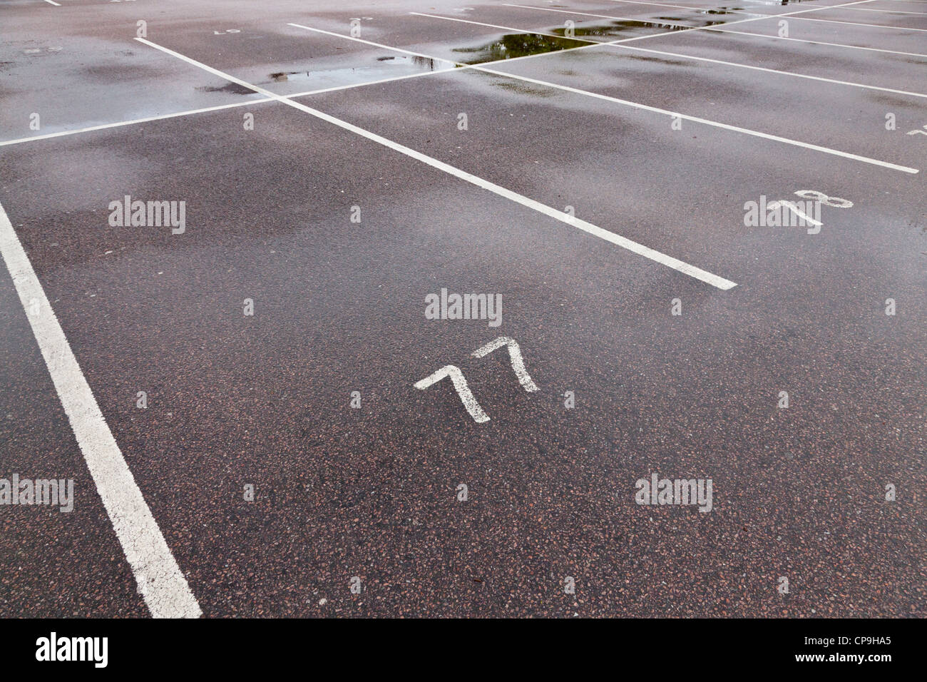 Parking spaces. Empty car park on a wet day, Nottinghamshire, England, UK Stock Photo