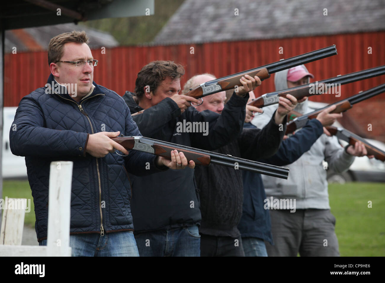 Men participate in a clay pigeon shooting competition for fun on a