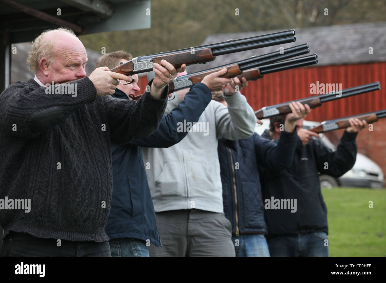 Men participate in a clay pigeon shooting competition for fun on a