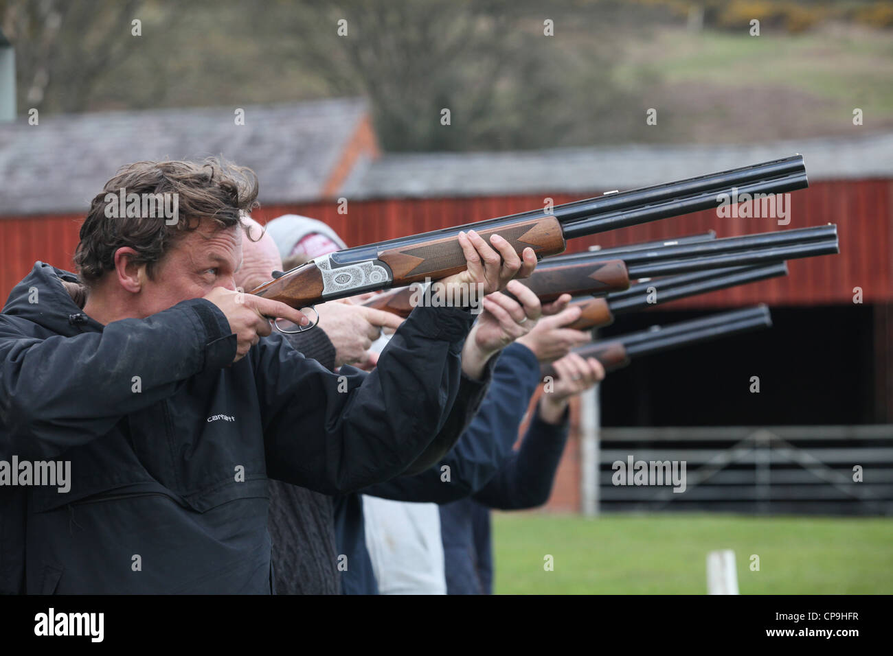 Men participate in a clay pigeon shooting competition for fun on a