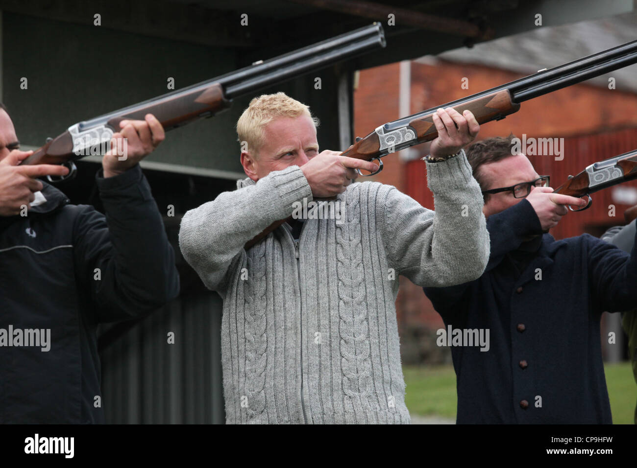Men participate in a clay pigeon shooting competition for fun on a