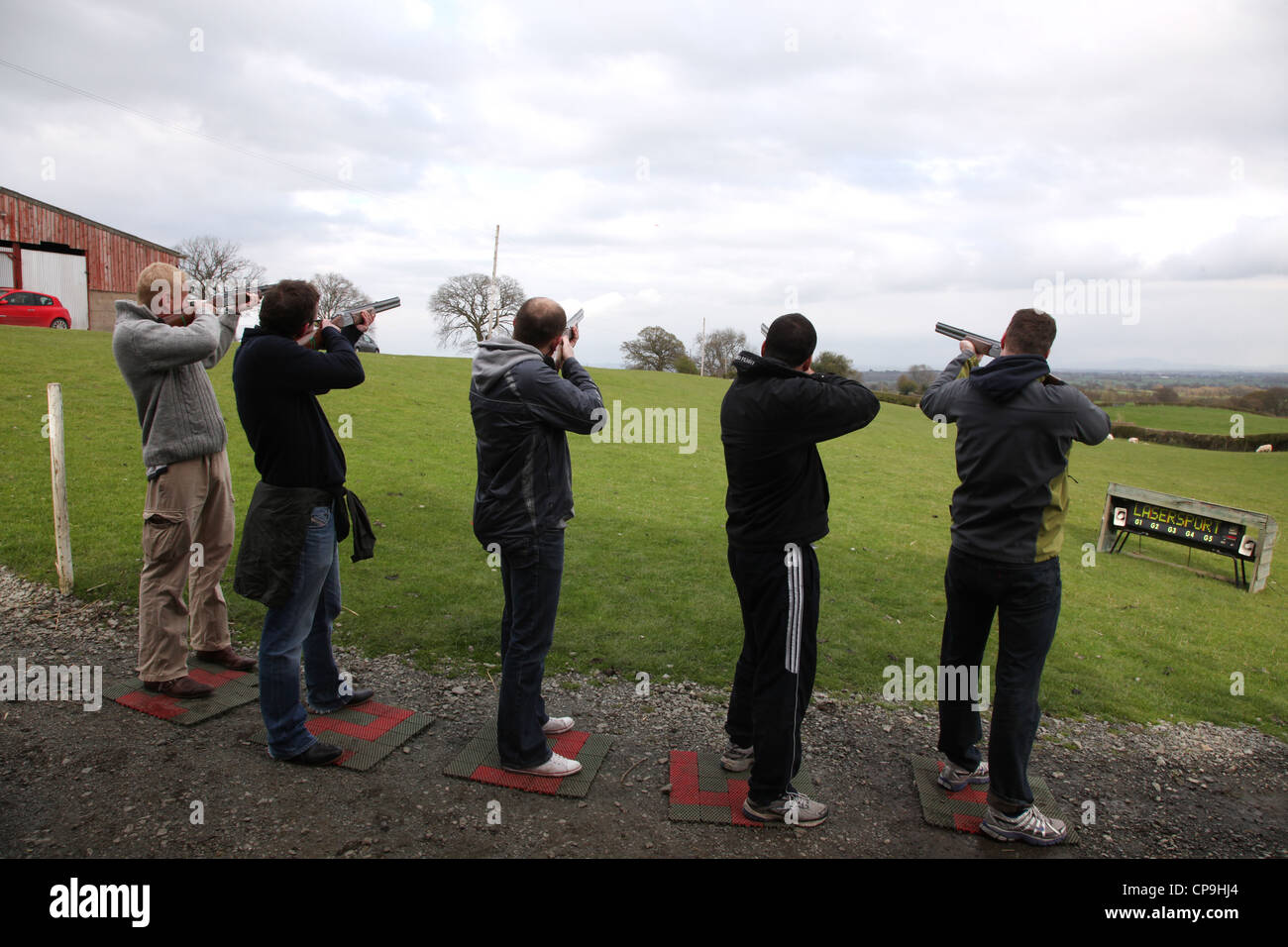 Men participate in a clay pigeon shooting competition for fun on a