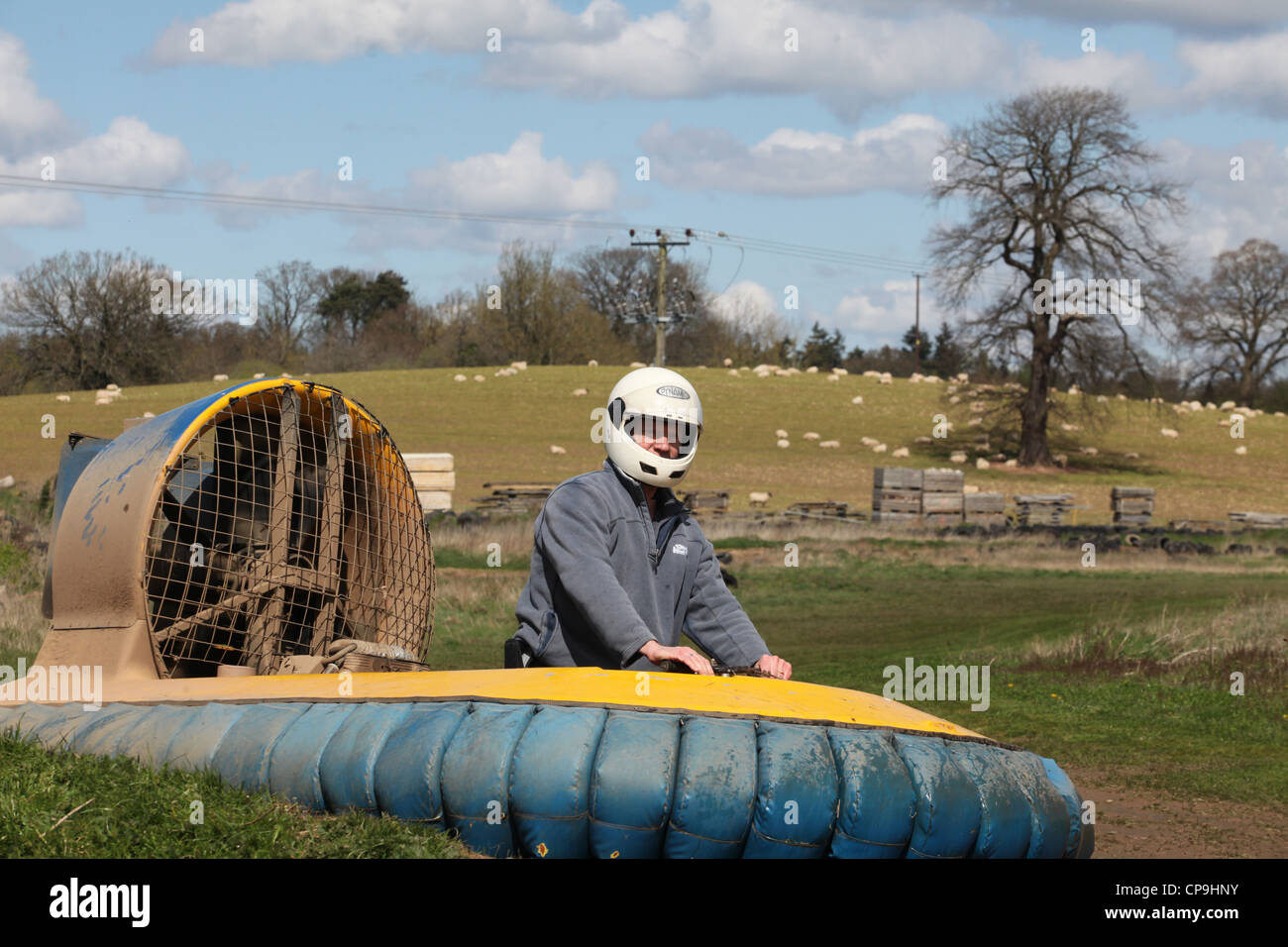 Man riding around a race course on a miniature hovercraft. The novel vehicle is popular as part of mens groups and stag parties. Stock Photo