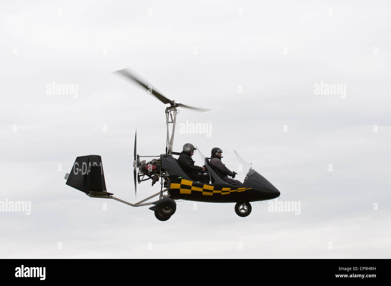 Stylish black Rotorsport MT-03 gyrocopter flies at Popham airfield near Basingstoke Hampshire England Stock Photo