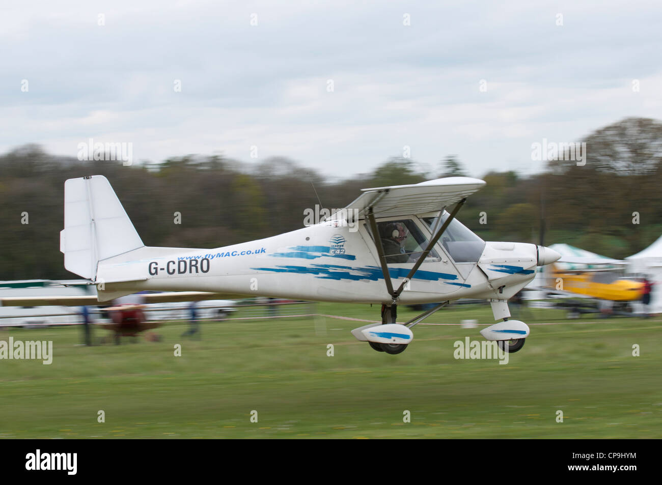 Ikarus C42 MIcrolight aircraft takes off from Popham airfield during the May Fly-In. Stock Photo
