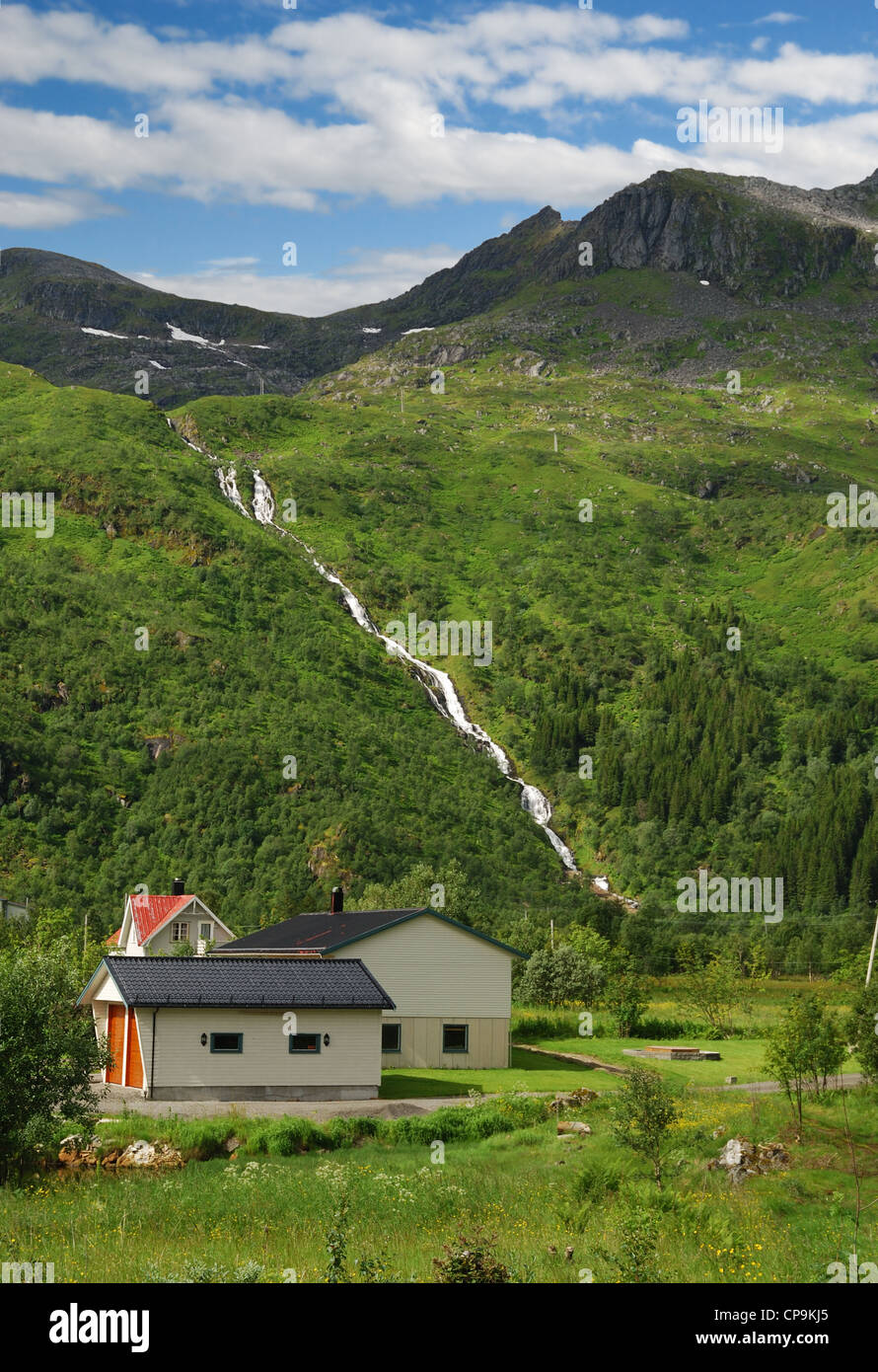 House under the mountain with falls Stock Photo - Alamy