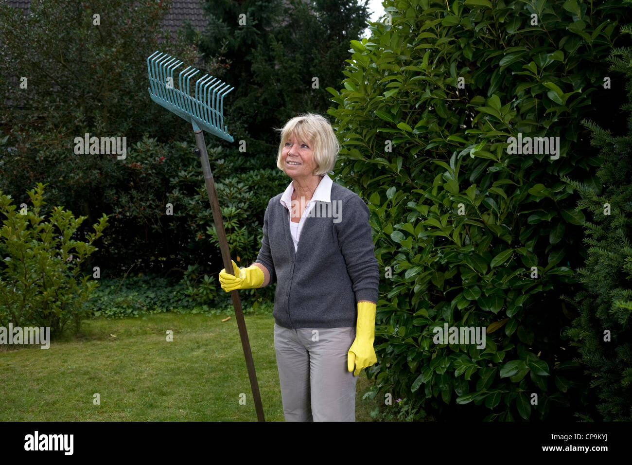 Woman working in the garden Stock Photo - Alamy