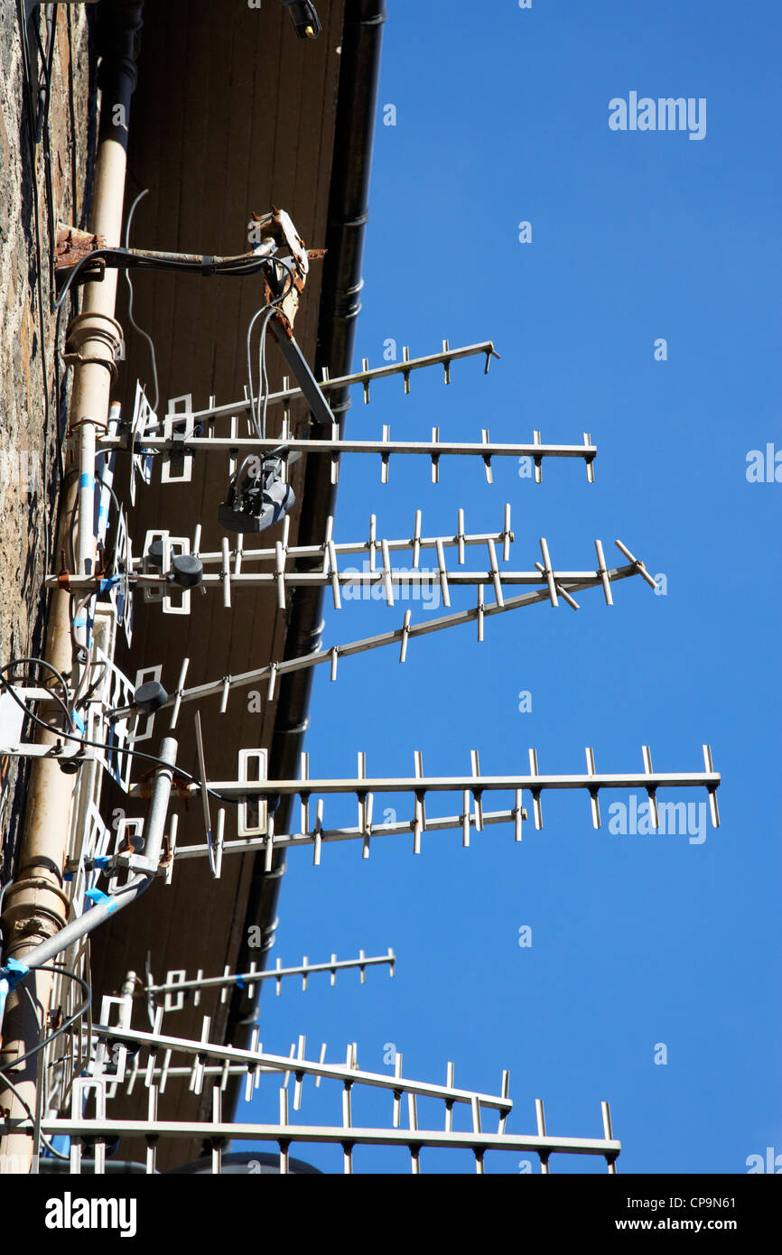 large amount of tv aerials on a wall of a tenement building in Scotland