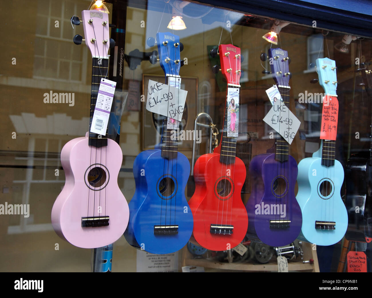 guitars for sale in shop window, York, England, UK Stock Photo