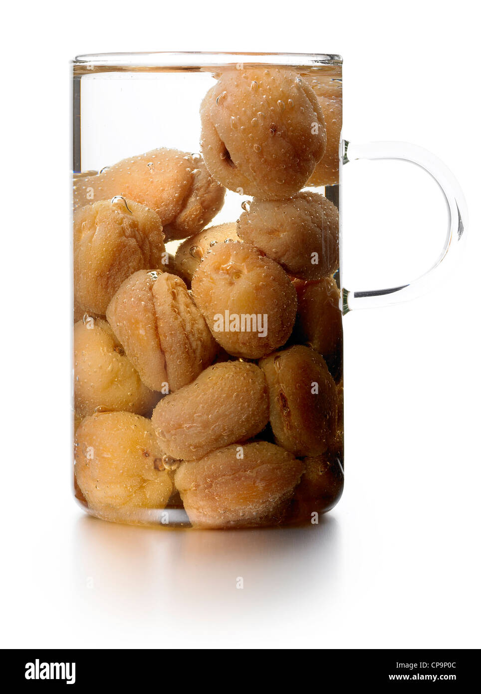 dried apricots soaking in glass jug Stock Photo