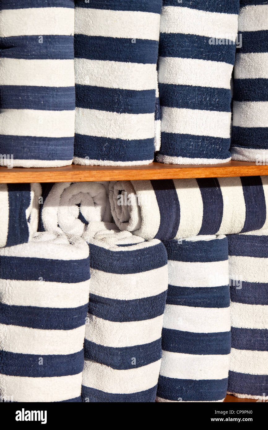 Stacks of towels beside a deck swimming pool on one of the luxury