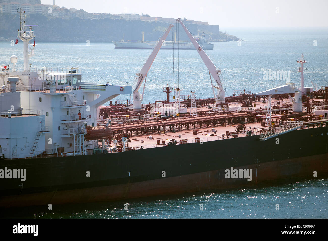 The decks of two Oil tankers alongside side each other doing ship to ship cargo transfer. Stock Photo