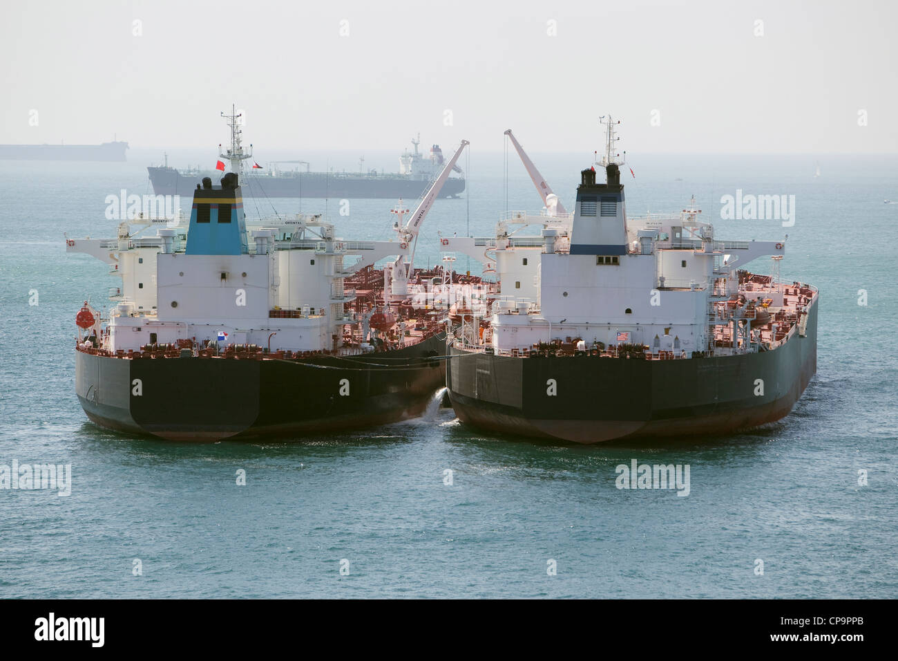 Two oil tankers alongside side each other doing ship to ship cargo transfer Stock Photo Alamy
