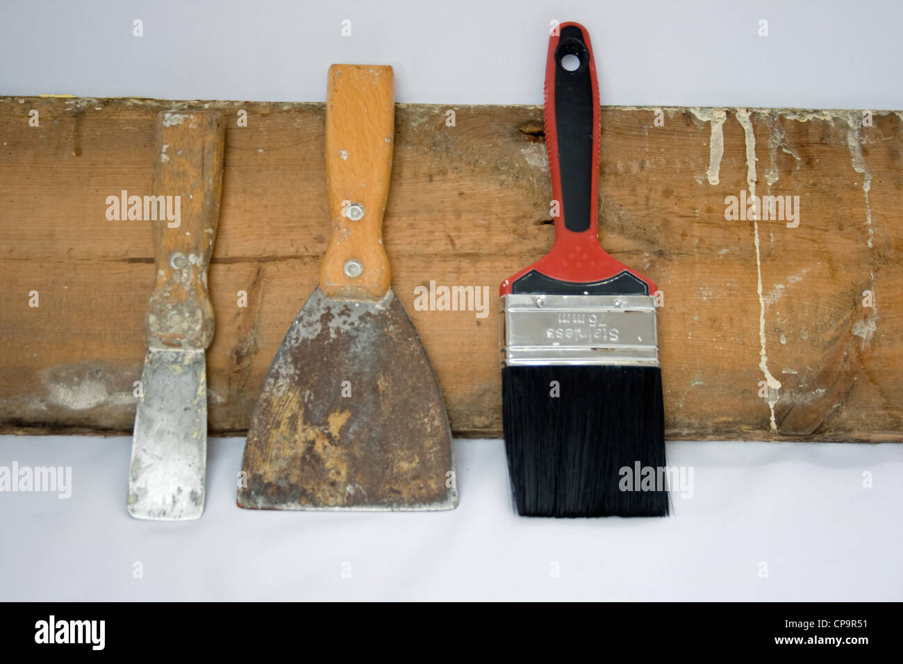 Painting And Decorating Tools Leaning Against A Old Piece Of