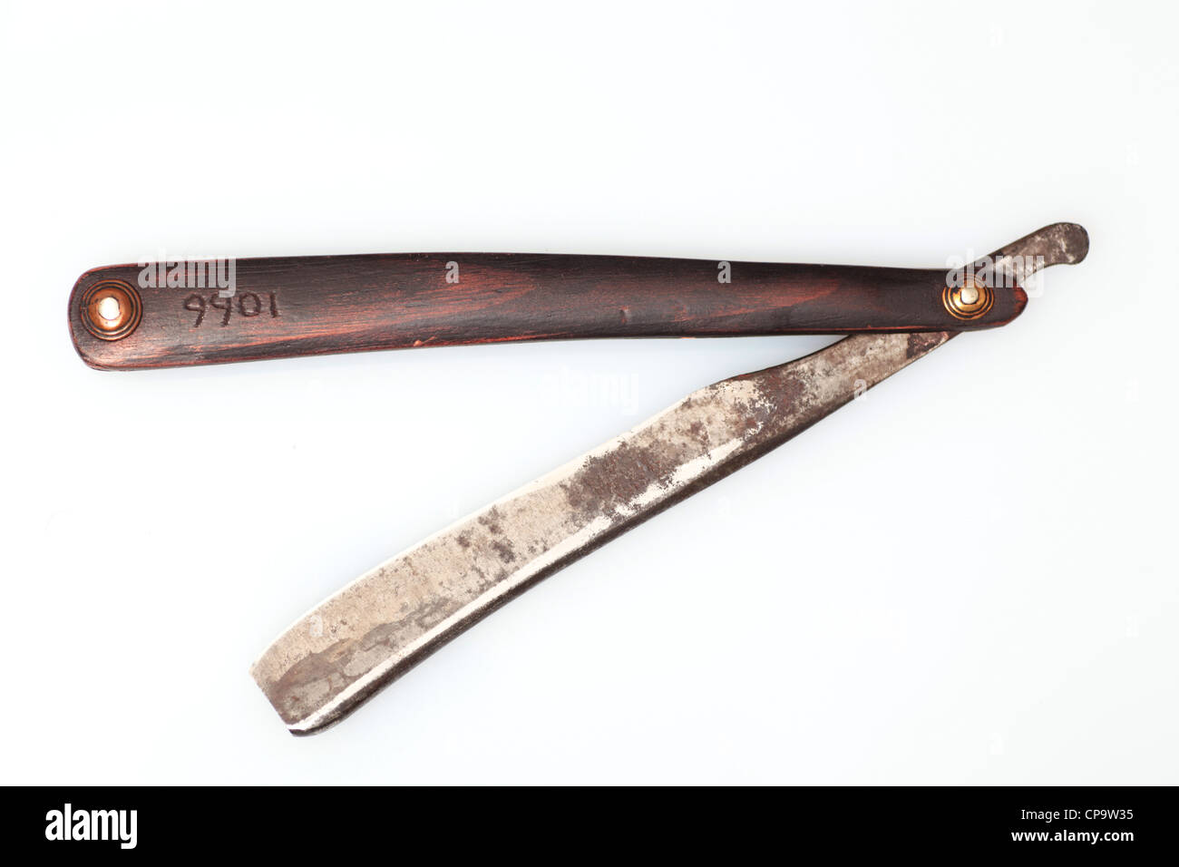 Antique wood handled straight edge razor c. 1800 against white background Stock Photo