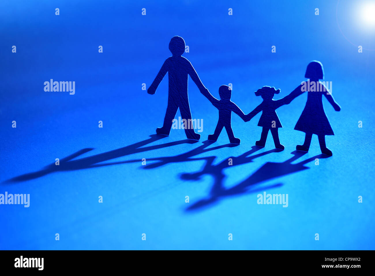 Paper chain family into the light Stock Photo