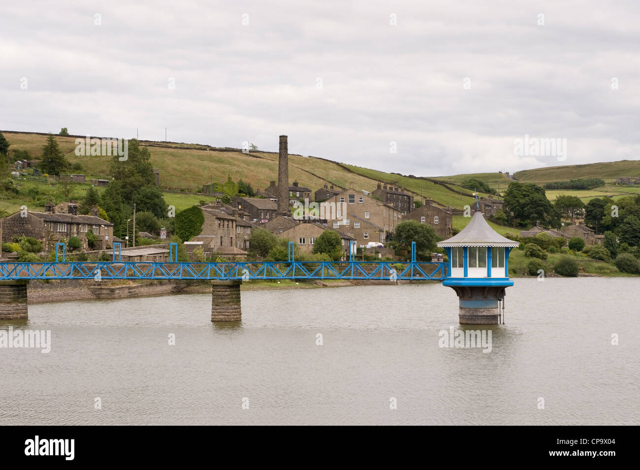 Calm water of Leeming Reservoir (footbridge, ornate valve tower) set in moorland of Pennine uplands - Nr Oxenhope village, West Yorkshire, England, UK Stock Photo