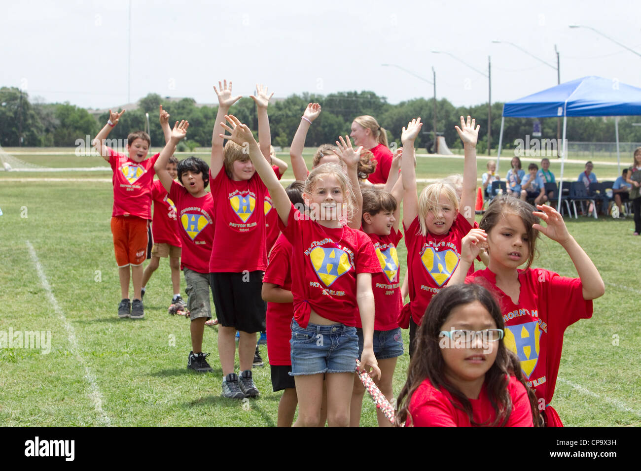 Second grade elementary school age kids participate in tugofwar