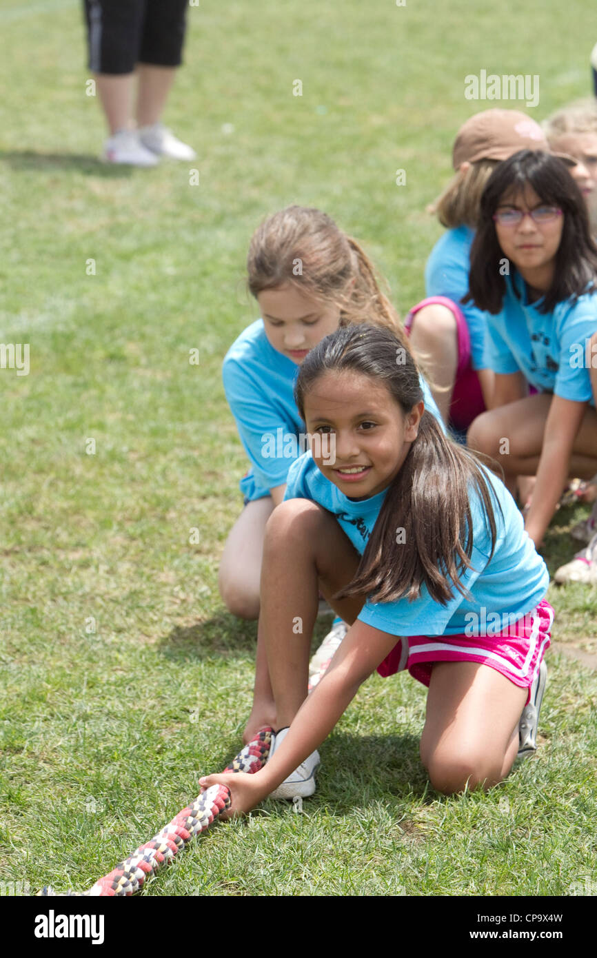 Second grade elementary school age kids participate in tugofwar