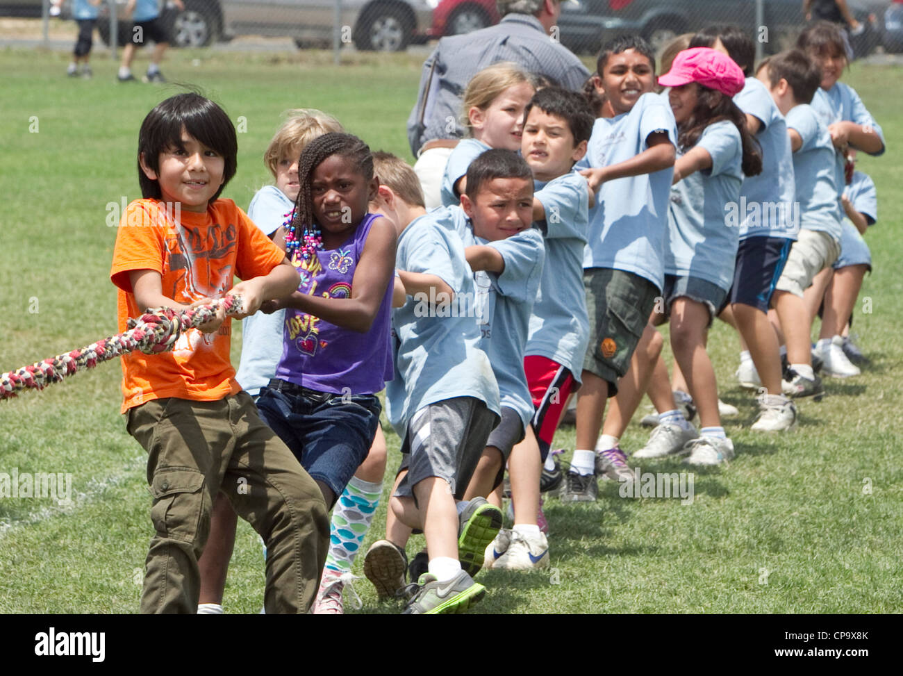Second grade elementary school age kids participate in tugofwar