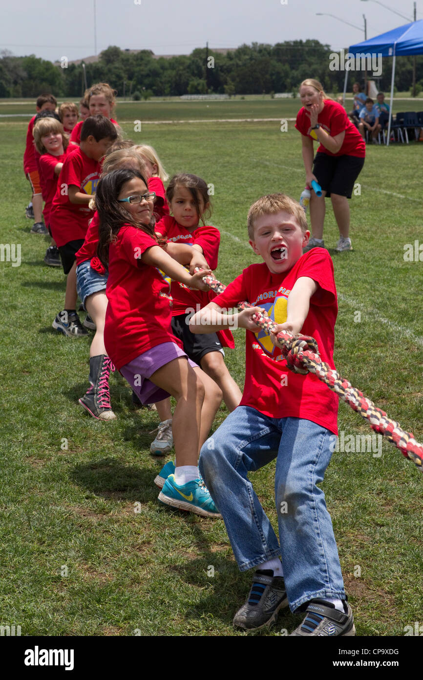 Second grade elementary school age kids participate in tugofwar