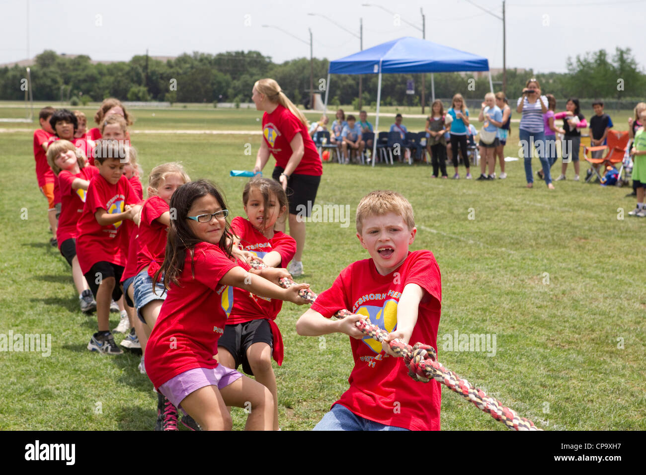 Second grade elementary school age kids participate in tugofwar