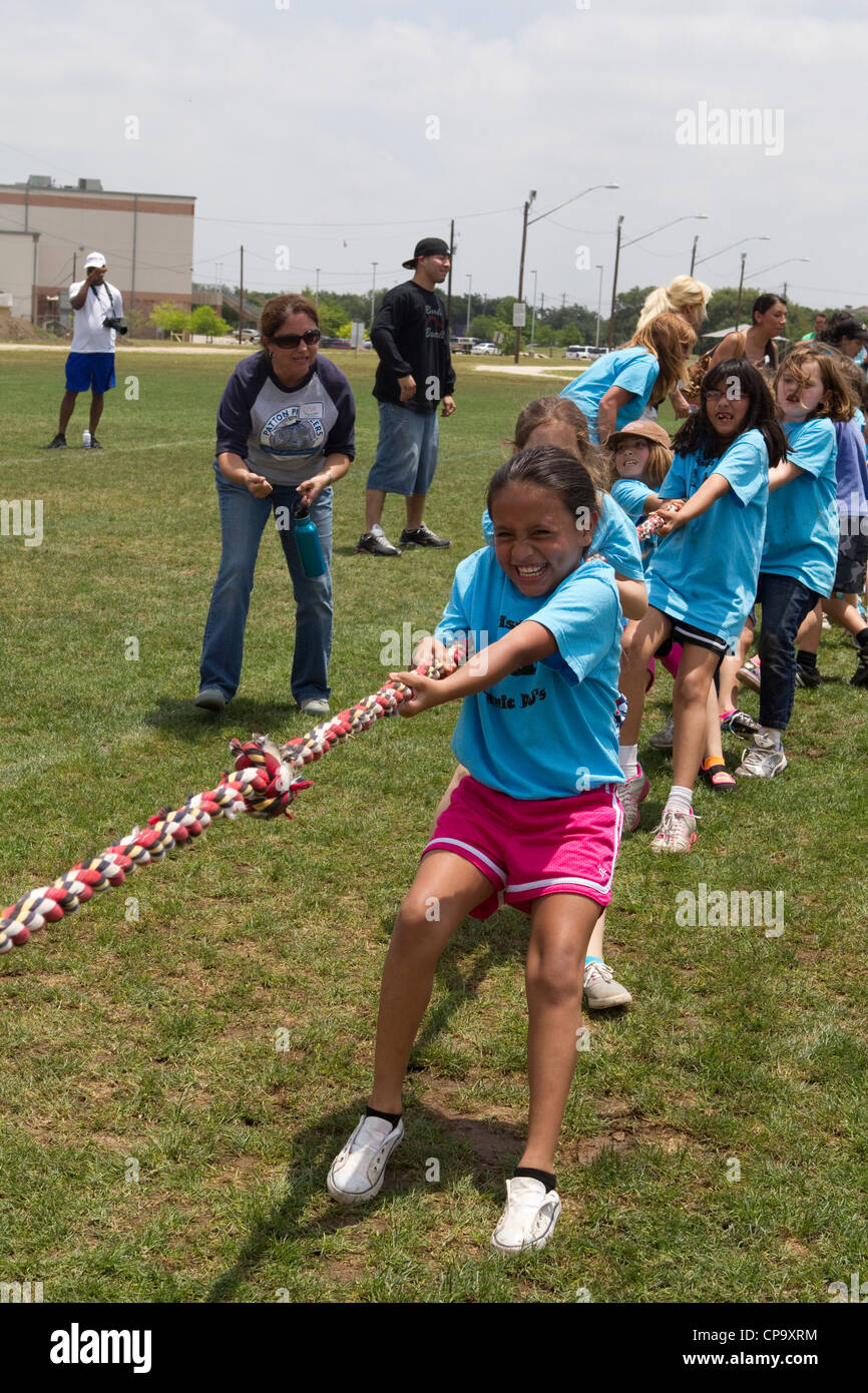 Second grade elementary school age kids participate in tugofwar