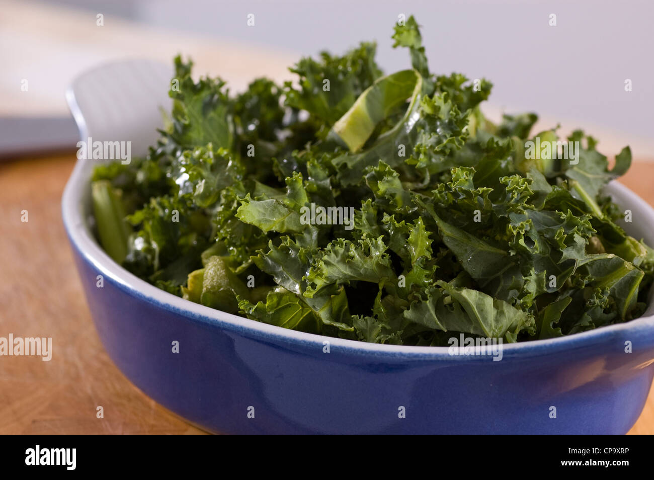 Side order of fresh green Kale vegetable in blue dish Stock Photo Alamy