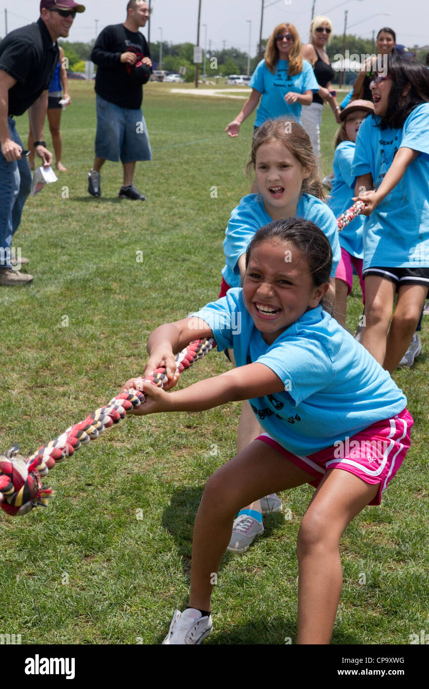 Second grade elementary school age kids participate in tugofwar