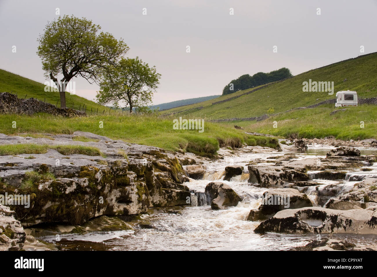 Campervan by River Wharfe, flowing through quiet scenic narrow valley, cascading over limestone rocks - Langstrothdale, Yorkshire Dales, England, UK. Stock Photo