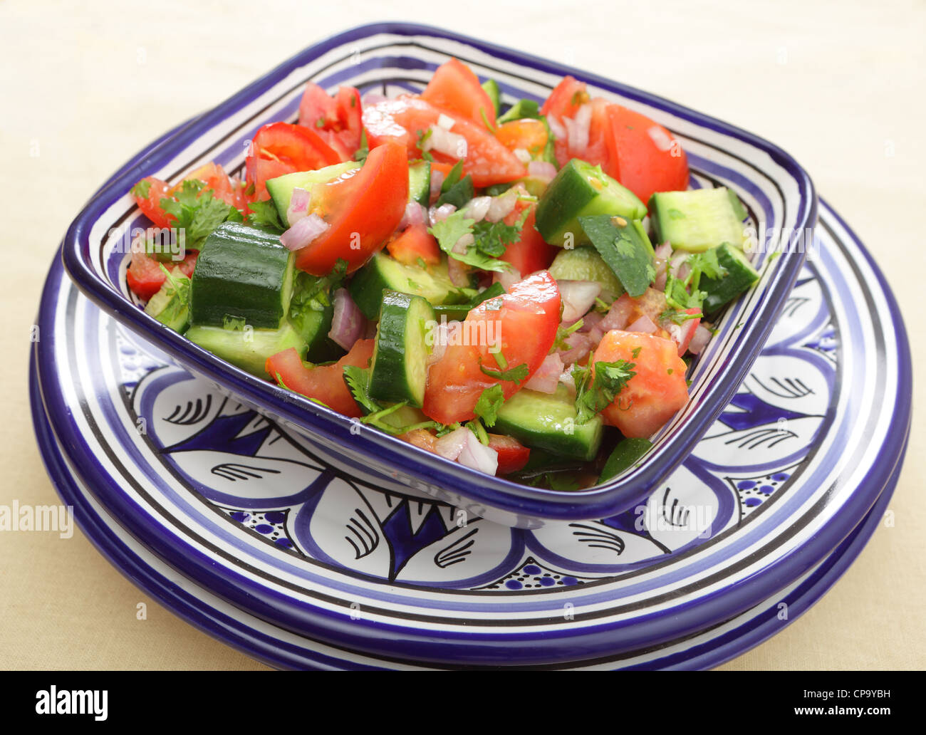A moroccan salad of tomato, cucumber, onion and coriander leaves tossed