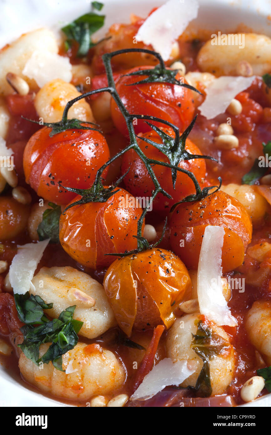 Gnocchi with Roasted Tomatoes on the vine and Parmesan Cheese Stock Photo