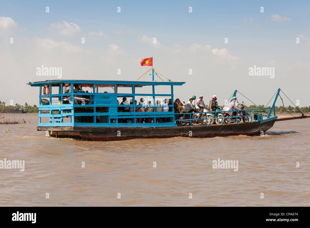 Passengers commuting on a small ferry boat, Cai Be, Mekong River Delta ...