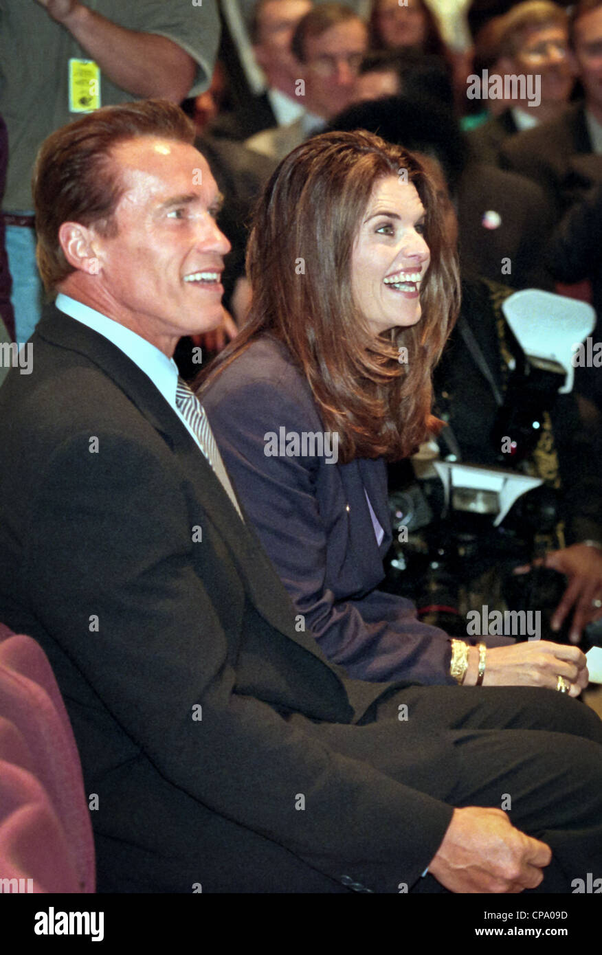 Actor Arnold Schwarzenegger sits with his wife Maria Shriver at the dedication of the Peace Corps headquarters September 15, 1998 in Washington, DC. Stock Photo
